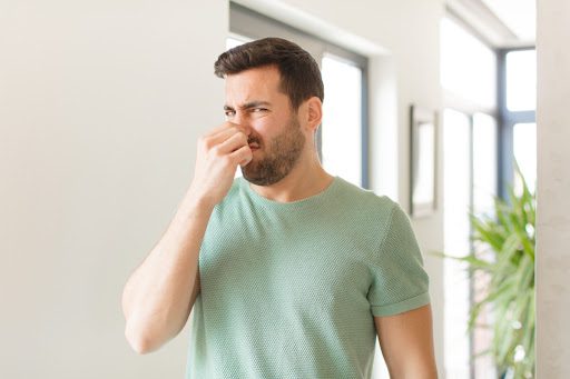 A man holding his nose.